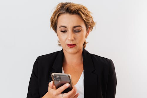 Woman in Black Blazer Holding a Cellphone