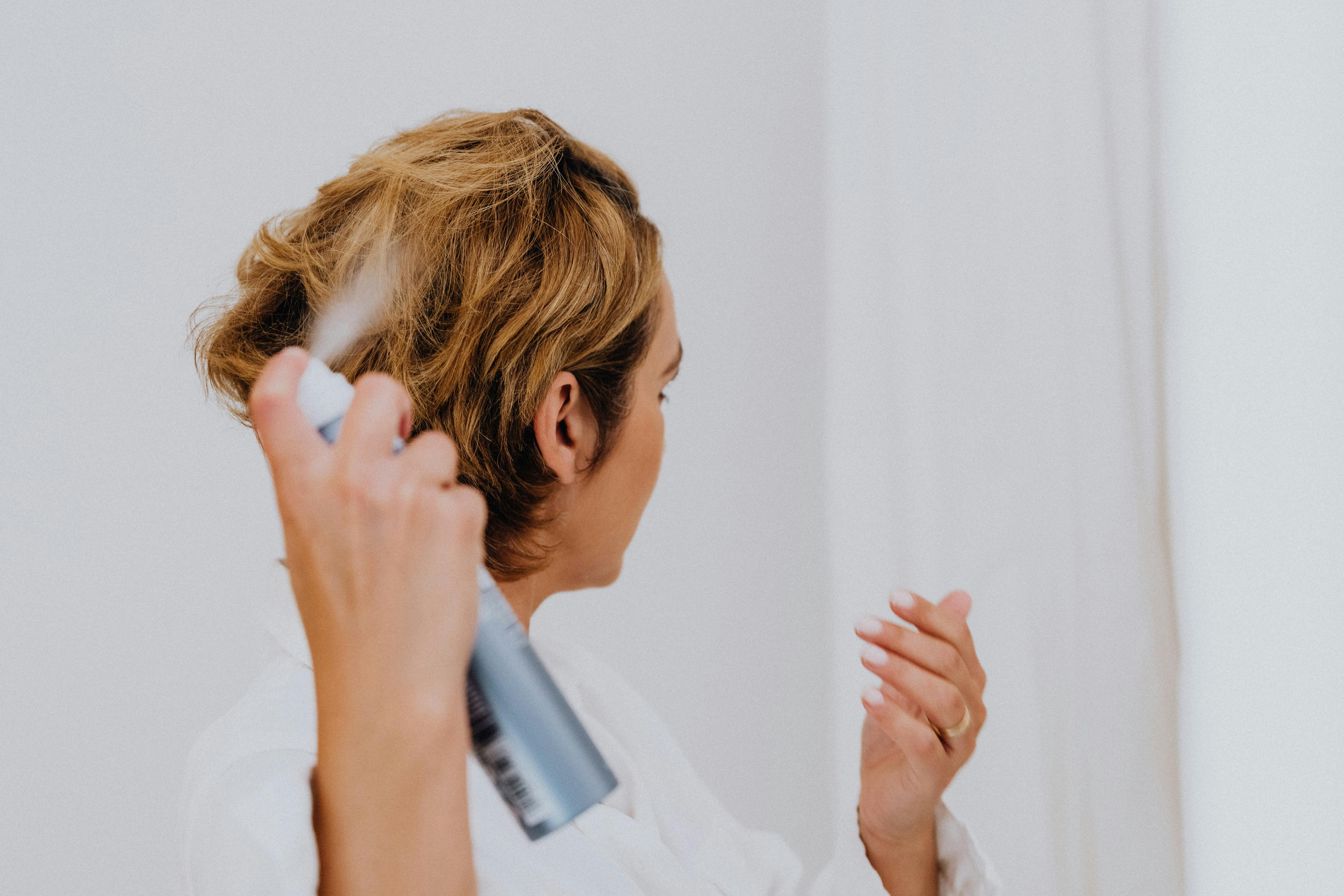 Free Woman Spraying Her Hair Stock Photo