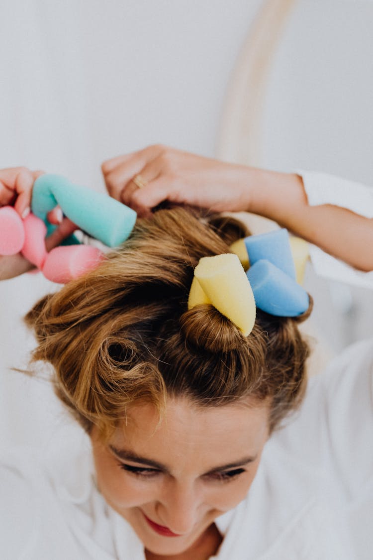 A Woman In Foam Hair Curlers