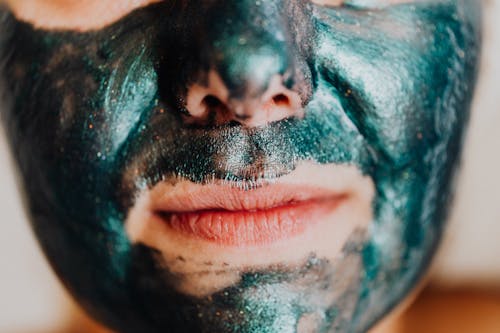 Free A Person Face on Green Facial Mask Stock Photo