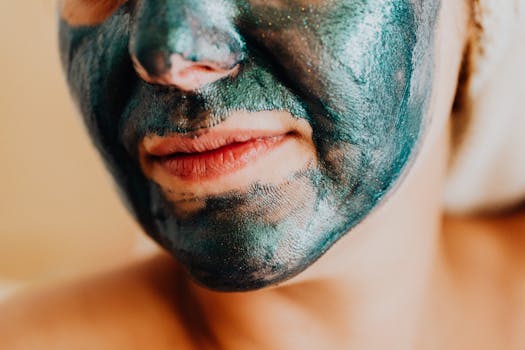 A close-up shot of a woman's face with a shimmering green facial mask for skincare.