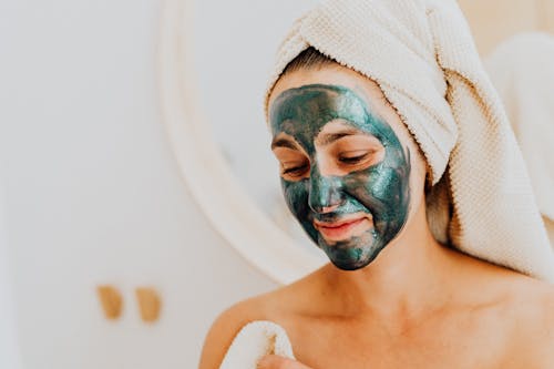 Free Person with Cosmetic Mask on Her Face Stock Photo