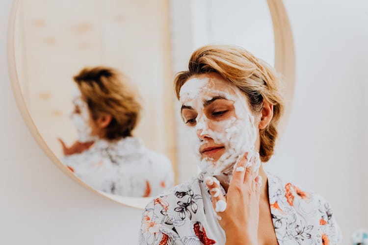 Woman Applying Skin Face Mask 