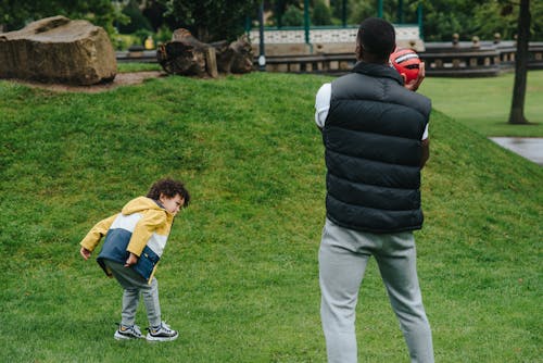 Unrecognizable black father playing with kid