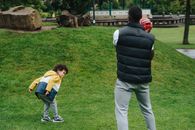 Unrecognizable black father playing with kid