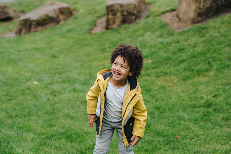 Cheerful Black Boy On Green Lawn