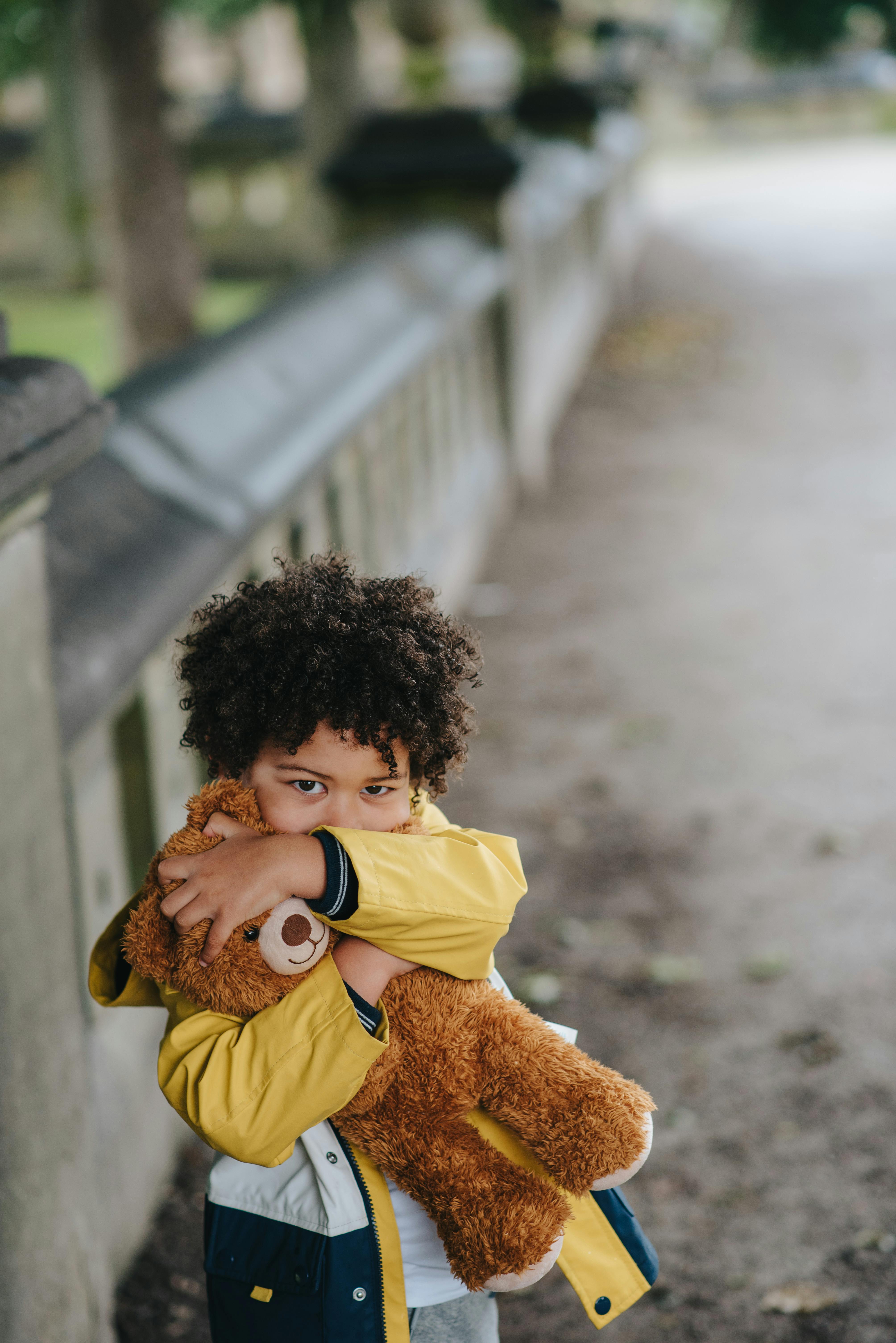 black kid with toy on street