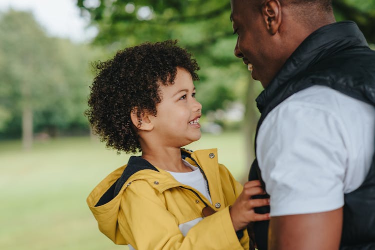 Crop Cheerful Black Man Interacting With Son In City Park