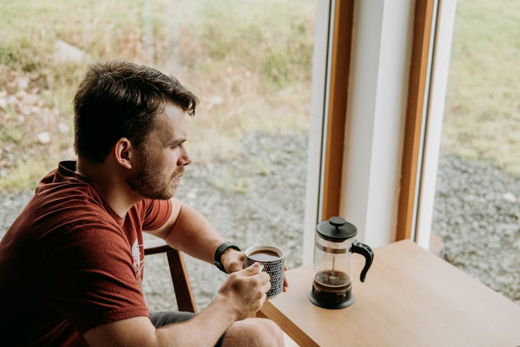 Pondering Man With Black Coffee Resting In Countryside House