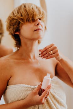 Woman applying facial serum with a pipette, focusing on skincare routine.