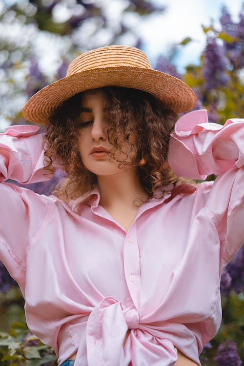 Woman in Pink Dress Shirt Wearing Brown Hat