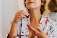 Woman in White Red and Blue Floral Shirt Holding Silver Ring