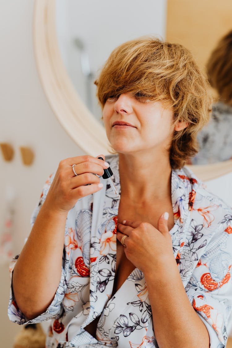 Woman Applying Perfume On Herself 