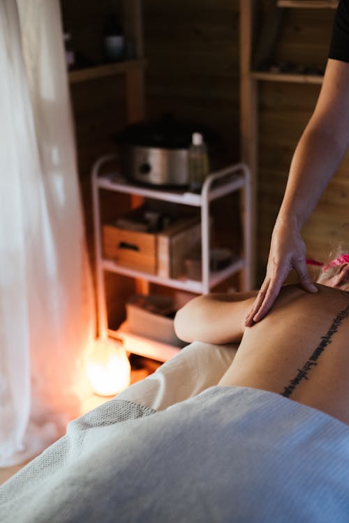 Free Crop masseur massaging back of female client Stock Photo