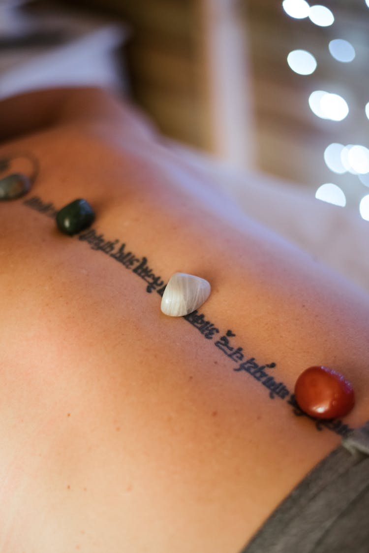 Crop Woman With Stones On Back