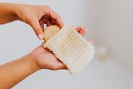 Person Holding White and Yellow Textile