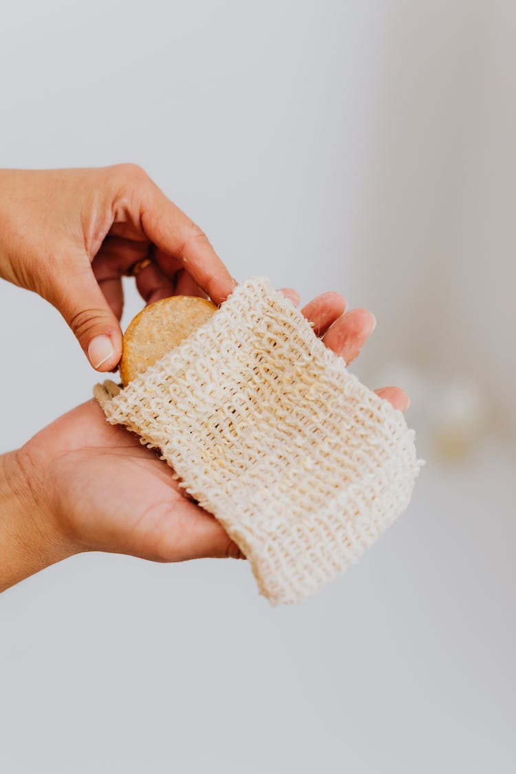 Hands Putting Cookie In Wool Bag