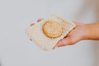 Person Holding White and Yellow Knit Textile