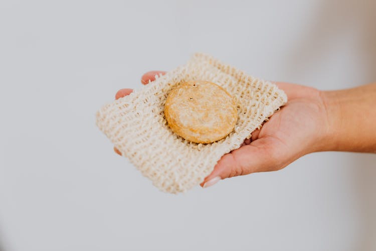 Close-up Of Woman Holding A Sustainable Washing Cloth And A Soap Bar 