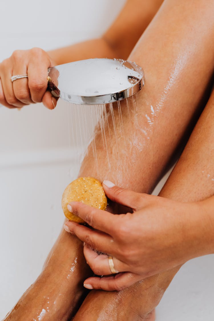 Person Scrubbing Her Legs 