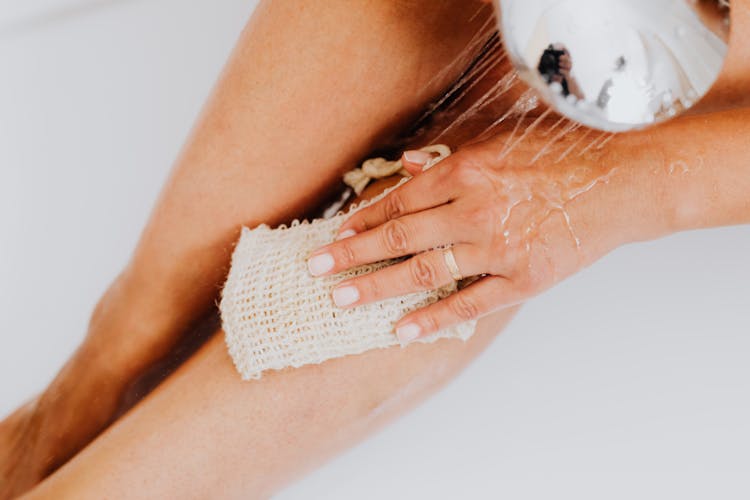 A Person Scrubbing Her Legs