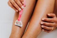 Pink and White Toothbrush on Persons Lap