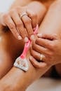 Person Using Razor on Legs