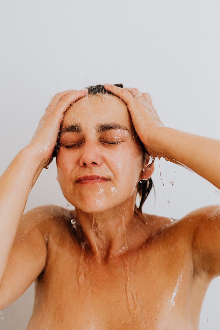 Naked Woman Under Water In Shower