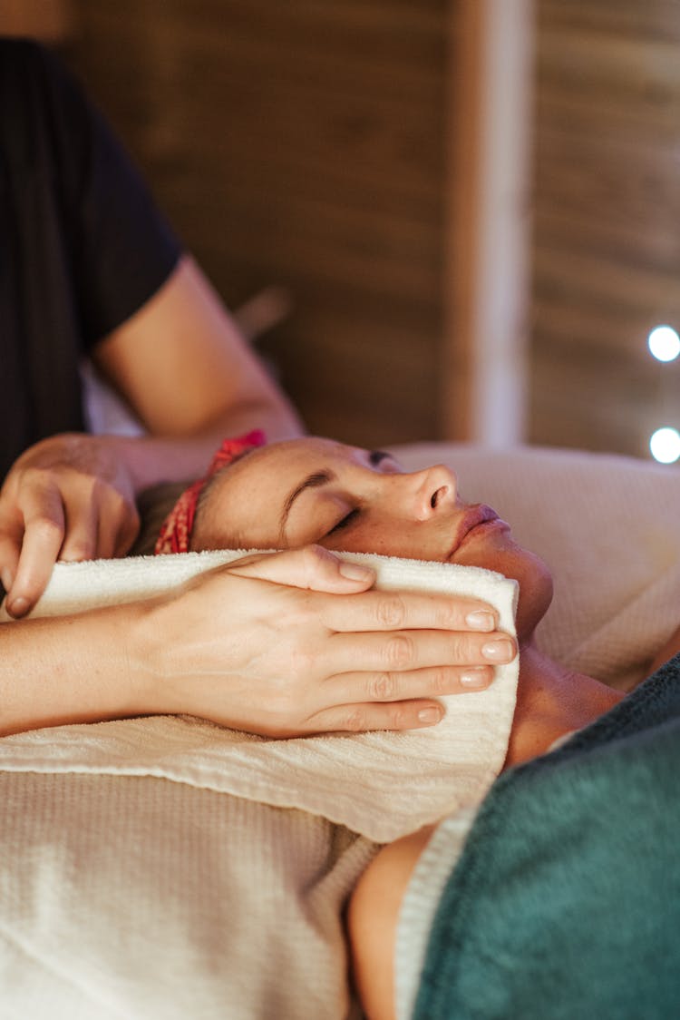 Female Relaxing On Massage In Spa Room