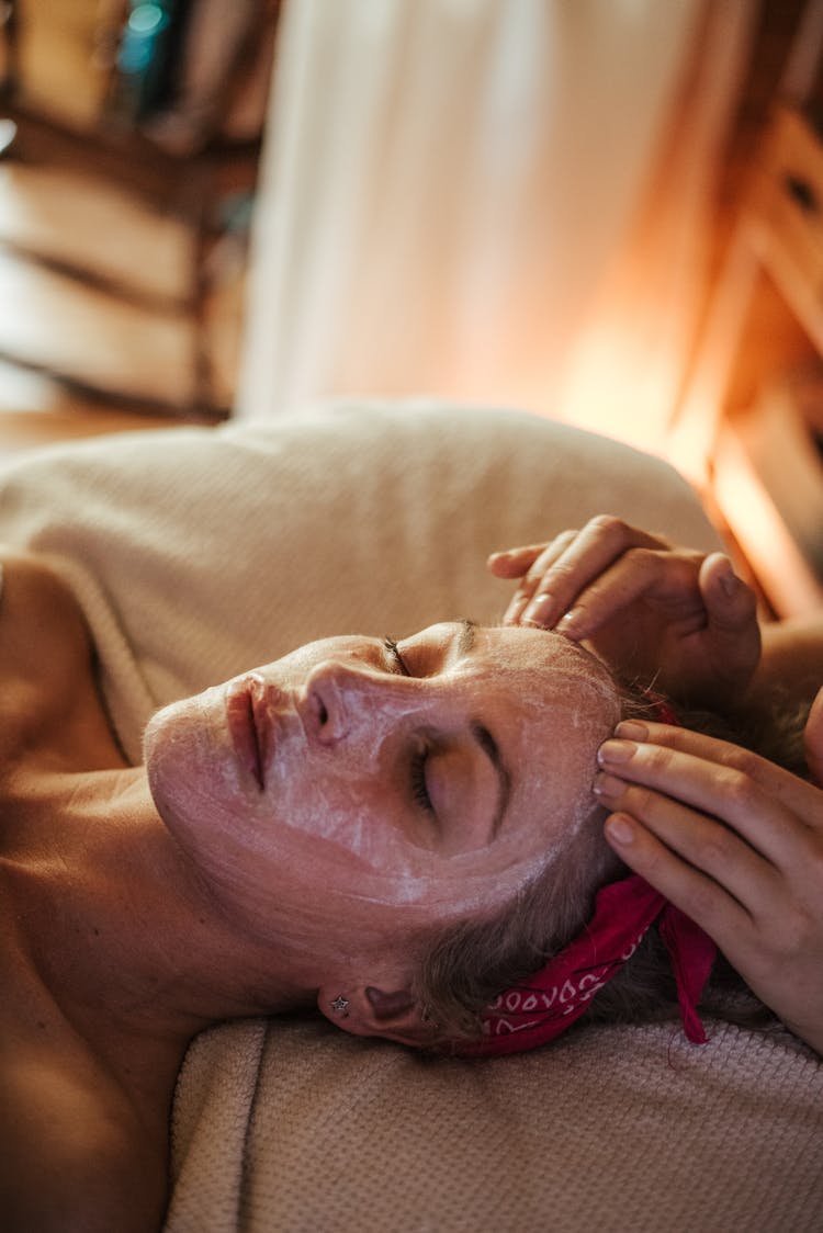 Woman Enjoying Massage While Mask On Face