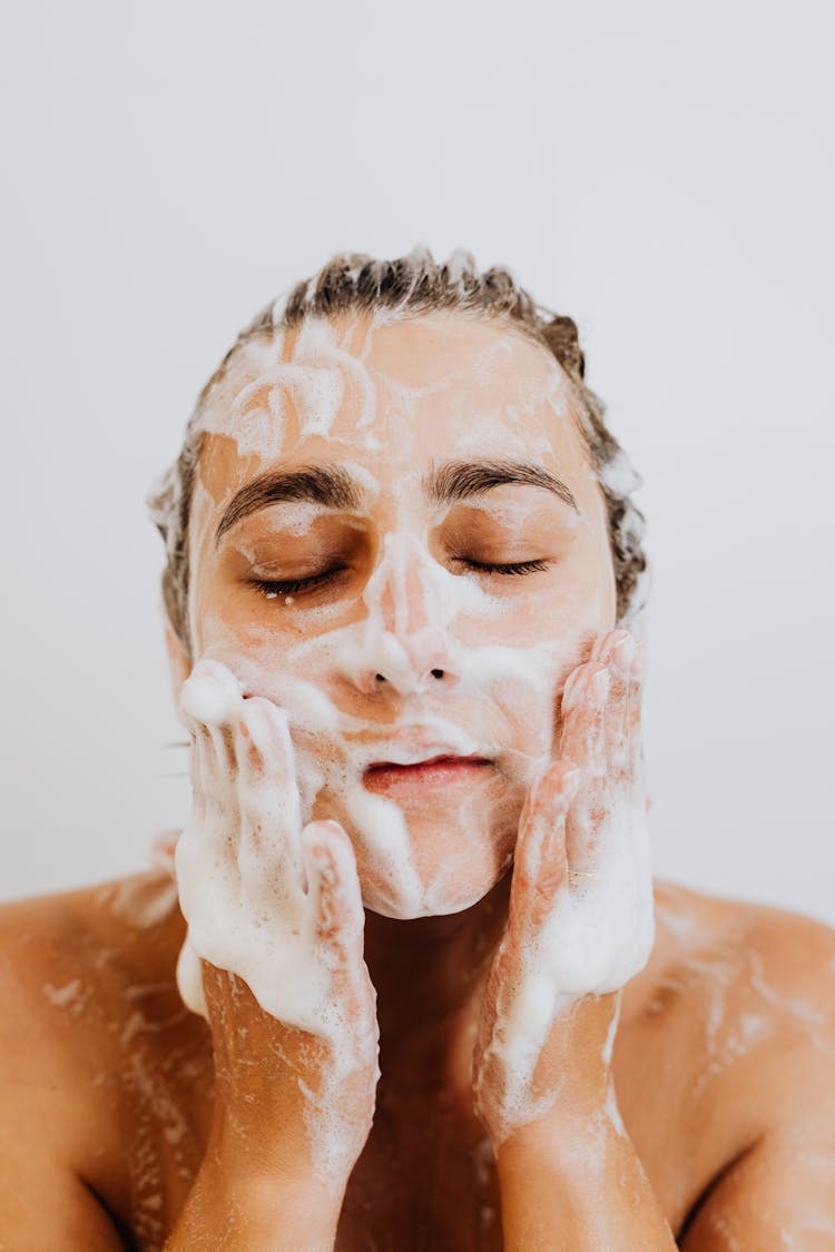 Woman Washing Face With Foam