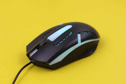 Black Computer Mouse on Yellow Surface