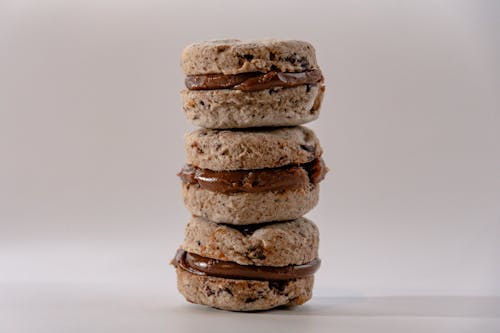 Stacks of Cookies with Chocolate Filling on a White Surface
