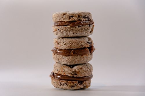 Free A stack of delicious chocolate-filled macaron cookies with a creamy filling. Stock Photo