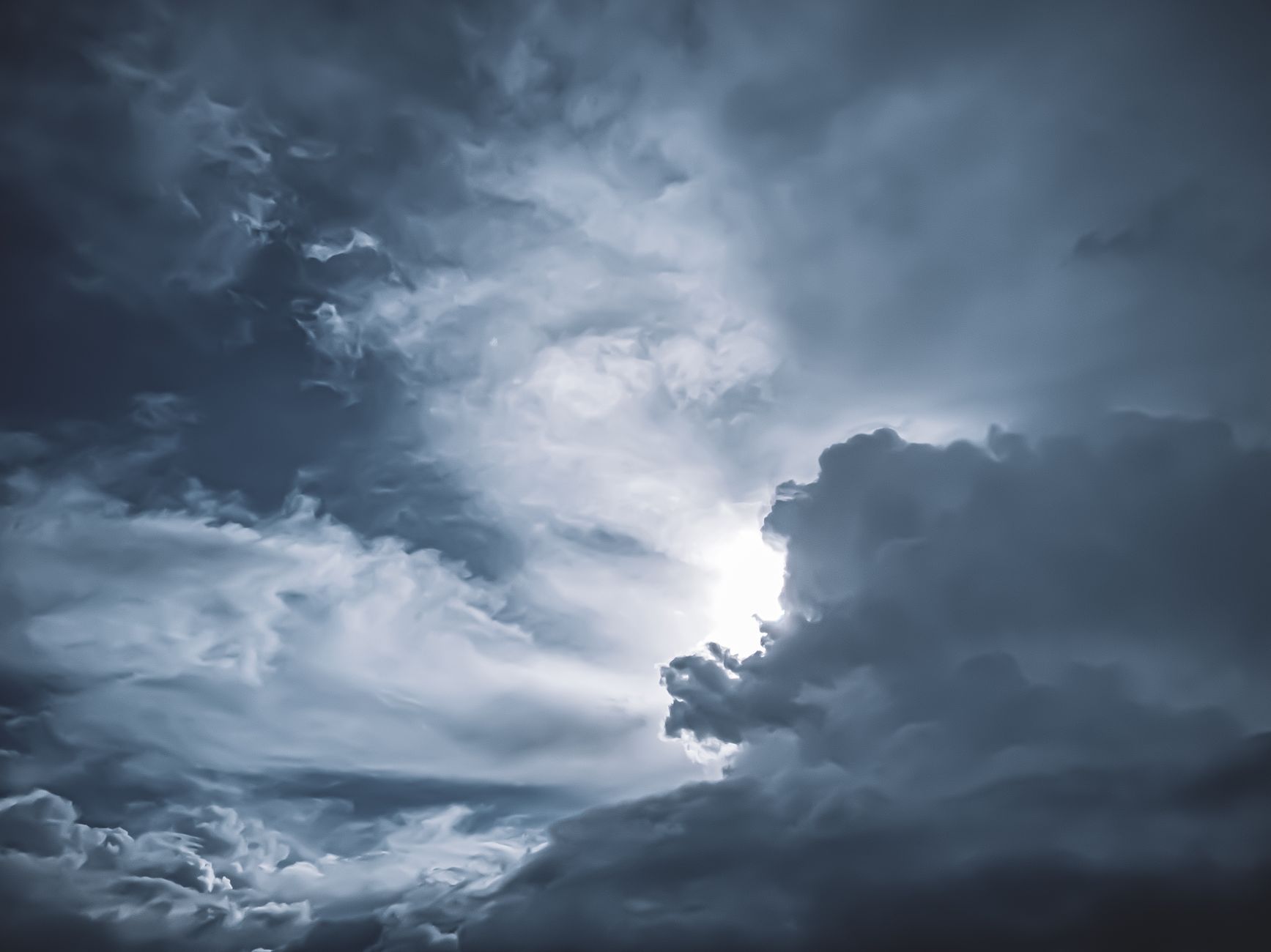 A stunning dramatic cloudscape with sunlight piercing through storm clouds, showcasing weather's beauty.