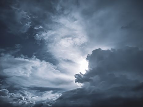 A stunning dramatic cloudscape with sunlight piercing through storm clouds, showcasing weather's beauty.