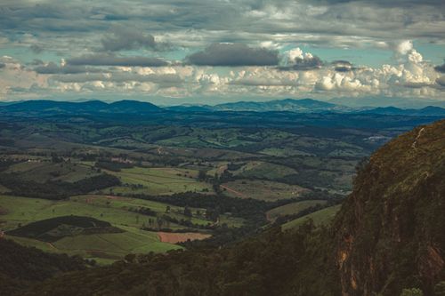 Free Picturesque landscape of hills and mountains on green grassy terrain in overcast weather Stock Photo