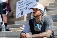 Pensive young black guy resting on street steps during anti racism protest