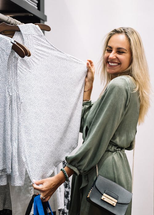 Happy Woman Holding Clothes
