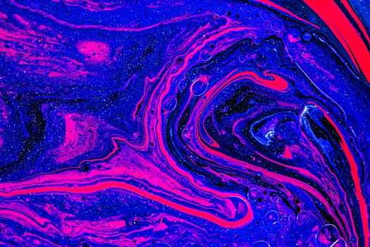 Dynamic abstract art with swirling blue and pink paint creating fluid shapes and vivid colors.