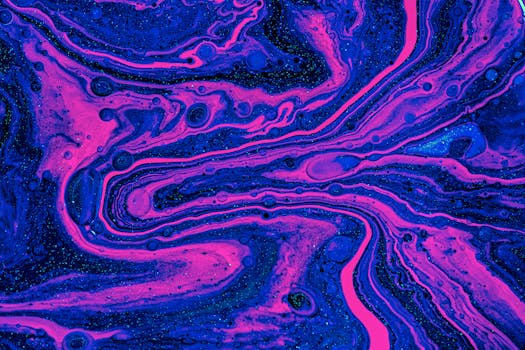 Dynamic swirls of magenta and blue create a vibrant abstract art piece with a fluid, flowing texture.