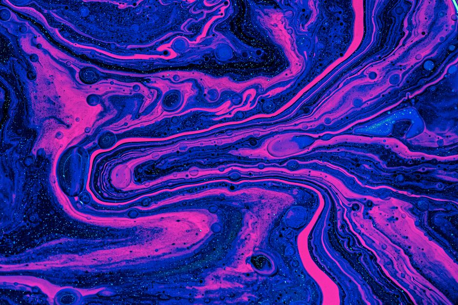 Dynamic swirls of magenta and blue create a vibrant abstract art piece with a fluid, flowing texture.