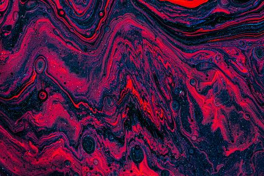 Dynamic abstract art featuring red, black, and white swirling patterns in fluid paint design.