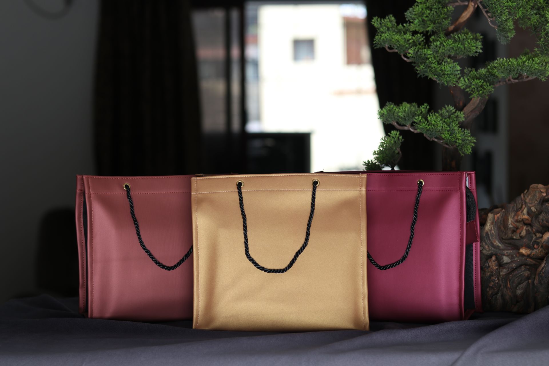 Luxurious leather shopping bags in rich colors elegantly arranged indoors.