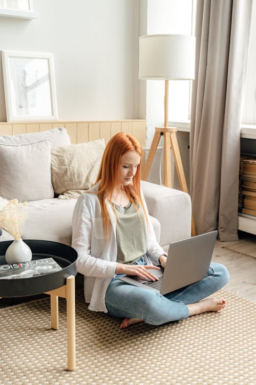 A Red-Haired Woman Working From Home