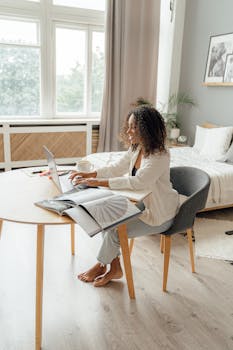 Woman working remotely on a laptop in a stylish home office, embracing a modern and comfortable work-from-home lifestyle.