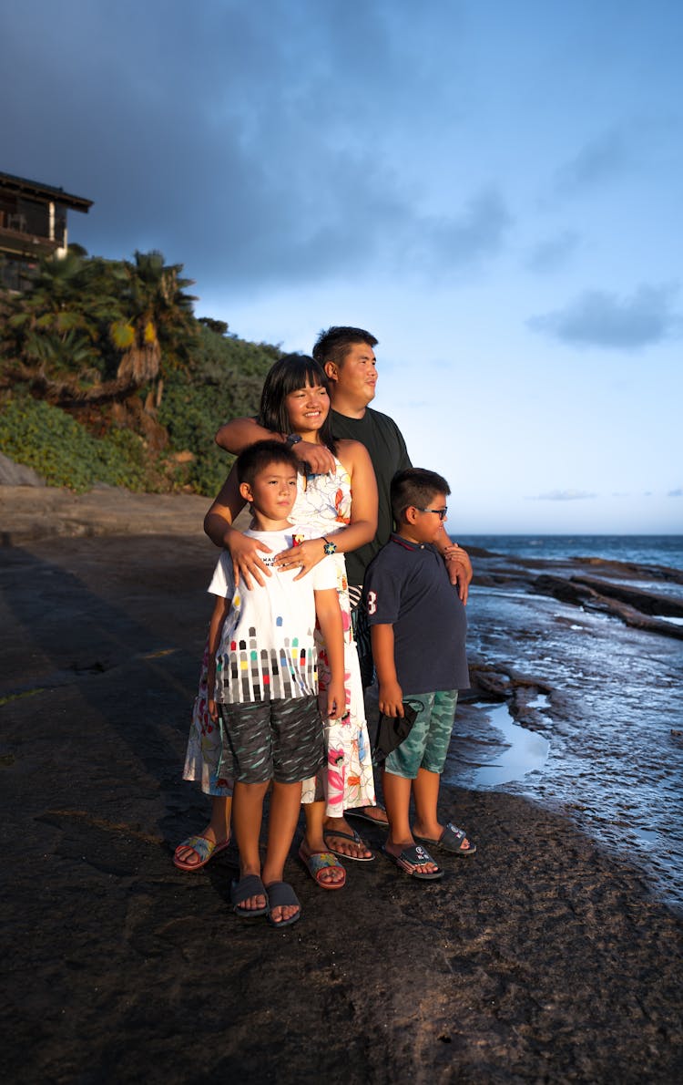 Cheerful Asian Family Standing On Sandy Tropical Shore