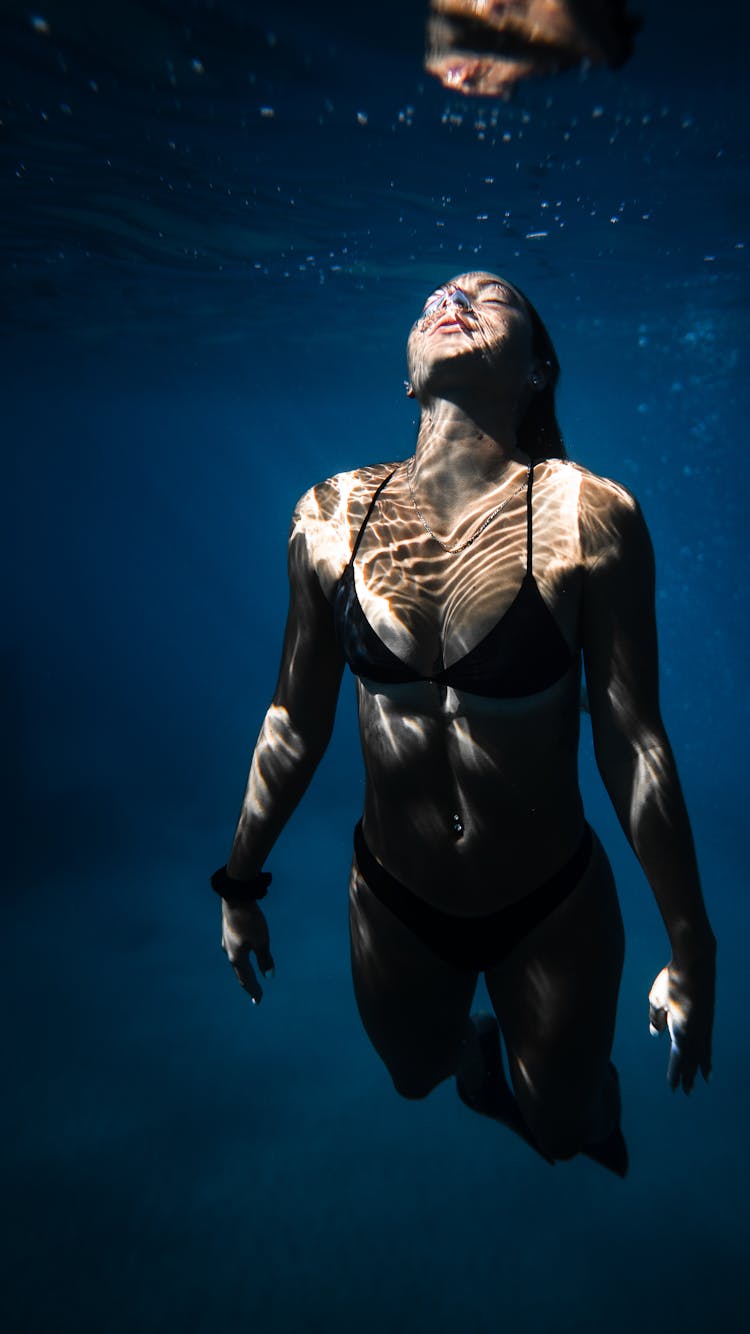 Attractive Woman Swimming In Blue Seawater