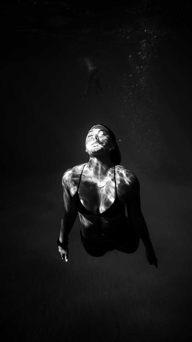 Attractive Woman Swimming In Deep Seawater