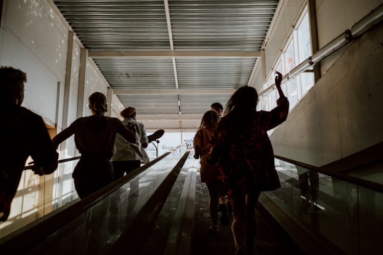 A Group Of Friends Running On A Walkalator